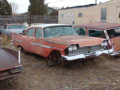 A red 4dr Fury parts car
